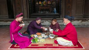 Chụp ảnh gia đình ngày Tết tại nhà với hoa mai và câu đối